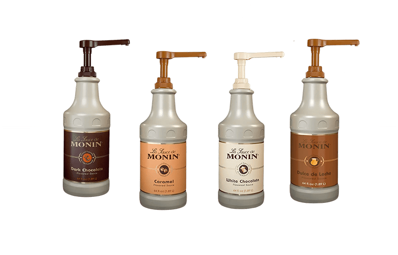 Four Monin syrup bottles on a green background with white lines.